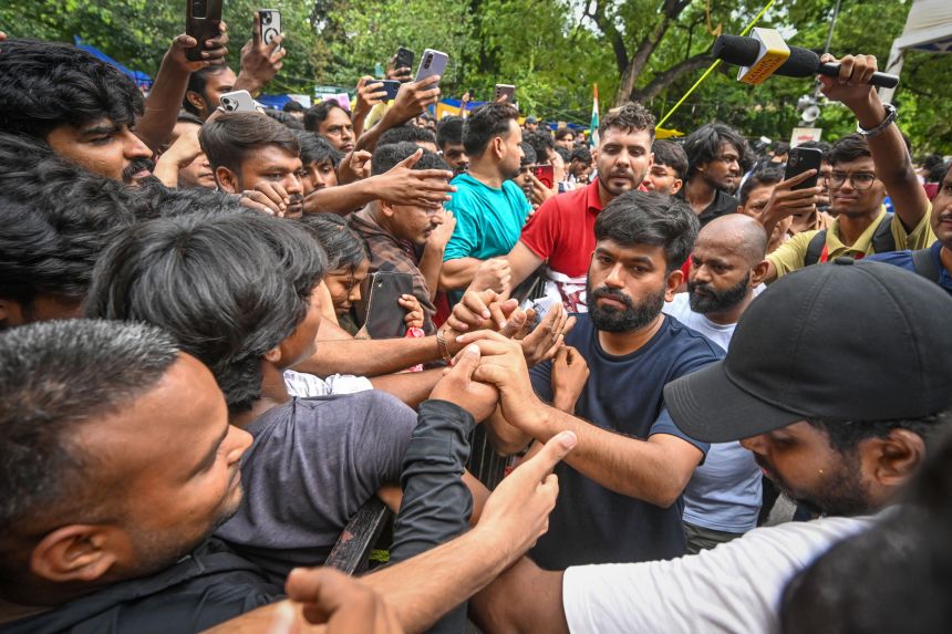 Large crowd of demonstrators gathered in a city street, evoking the scale of the Jantar Mantar protest
